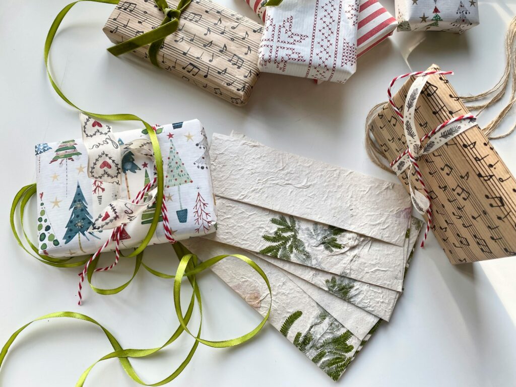 High-angle view of creatively wrapped Christmas gifts and decorative paper, perfect for holiday inspiration.
